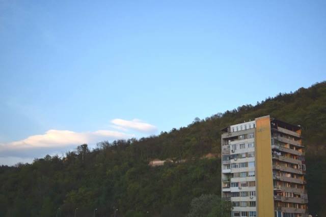 A high-rise building, in front of hill